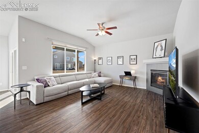 Living room featuring lofted ceiling, gas fireplac