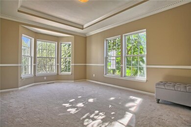 Formal Dining Room with bay window and tray ceilin