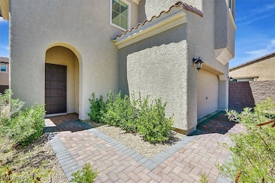 Doorway to property featuring a garage and stucco siding