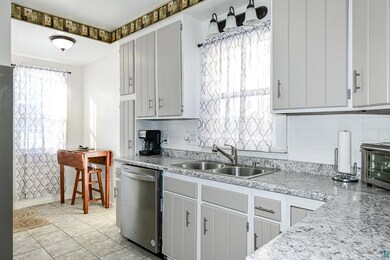 Kitchen with stainless steel dishwasher, sink, dec