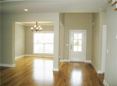 Sparkling hardwood floors in foyer, formal dining,
