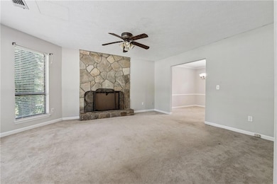 Unfurnished living room featuring ceiling fan, bas