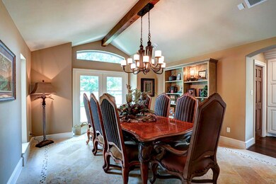 Spacious dining room with exposed knotty alder wood beam, custom tile work, and lots of natural light. Entire house has new double pane low e windows wind storm certified.
