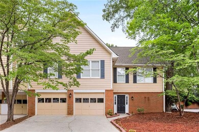 View of front of home with brick siding, a shingle