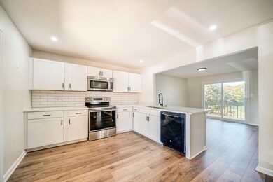 Kitchen with kitchen peninsula, light hardwood / w