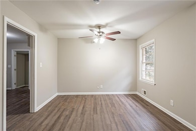 Empty room featuring dark wood-type flooring and c