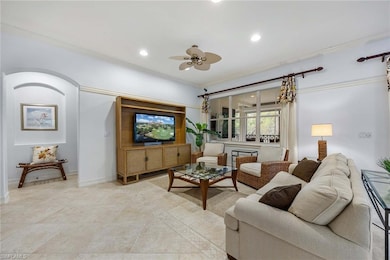 Open-concept living room filled with natural light and seamless flow to the lanai.