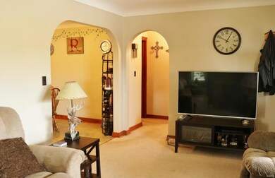 Arched doorways leading into the hallway and dinin