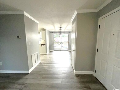 Hallway with crown molding and hardwood / wood-sty