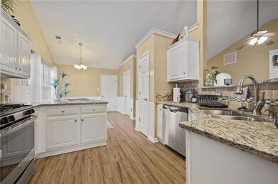 Kitchen featuring a peninsula, appliances with sta