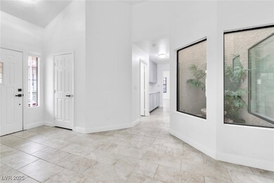 Entryway featuring baseboards and a towering ceili