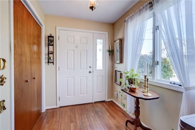 Front entry with new door, coat closet, and hardwo