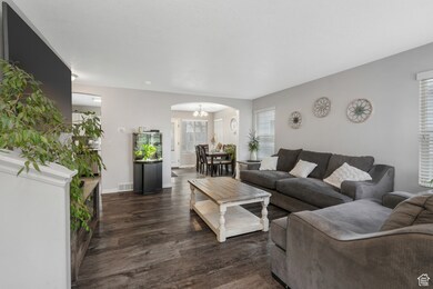 Living room featuring an inviting chandelier and dark hardwood / wood-style flooring