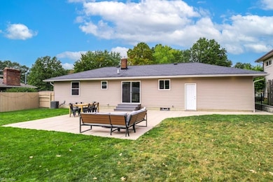 Back of property featuring a lawn, a patio, and an