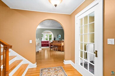 Hallway featuring ornamental molding and light har