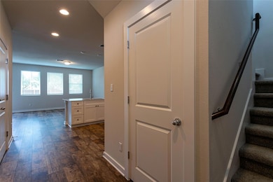 Hall with recessed lighting, dark wood-type floor