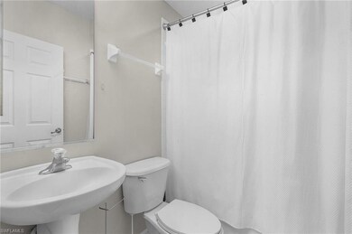 Bathroom featuring toilet and shower / bath combination with curtain
