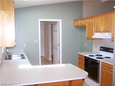 Kitchen. Spacious kitchen with bar! Great home for entertaining and enjoying! Newly remodeled cabinetry and hardware! Wood Floors freshly sanded and finished! Much more! This door leads to the 2 extra bedrooms/bonus rooms, laundry room, and a seperate mud room!!