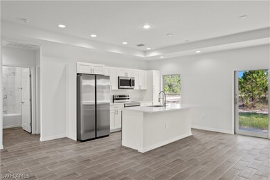 Kitchen with a center island with sink, light hard