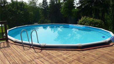 Pool in back yard has a deck that surrounds the po