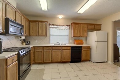 Massive kitchen area overlooks den and dining room