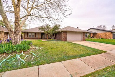 Single story home featuring a front yard and a gar