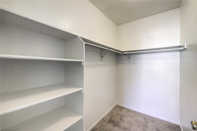 Walk-in closet at primary bedroom