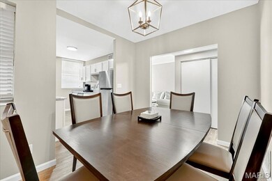 Dining area featuring light wood finished floors and a chandelier