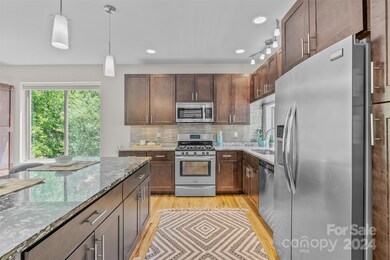 Natural gas stove and stainless steel appliances.