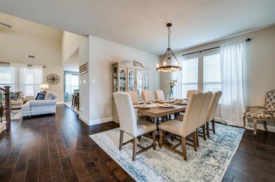 Dining room featuring wood floors and custom light