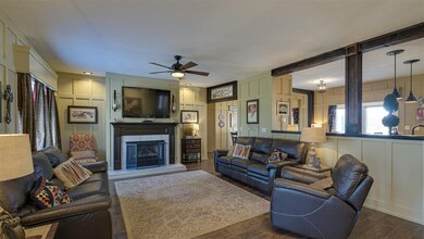 Enter the home and you're greeted by a spacious open floor plan and rich engineered hardwood floors. Notice the board and batten trimmed walls. This detail can be found throughout the home.