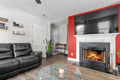 Living room with wood-type flooring and a textured ceiling
