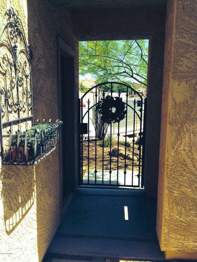 Private Courtyard Entry with Iron Gate