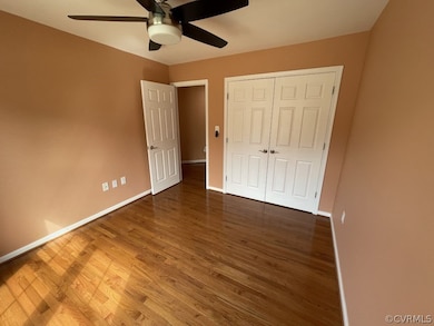 Unfurnished bedroom with a closet, dark hardwood /