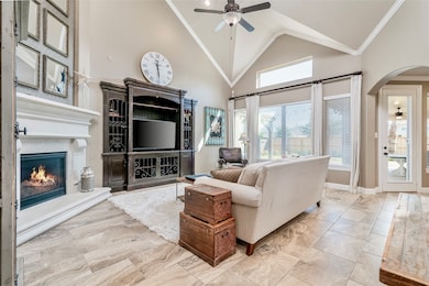 Step inside this spacious family room under a distinctive vaulted ceiling with an abundance of natural light. The room features a lovely gas fireplace and an attractive built-in entertainment center perfect for a large television. A wall of windows overlooks the backyard. Notice the glass-paned door that provides access to the covered backyard patio.