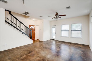 Entrance foyer with ceiling fan, concrete floors,