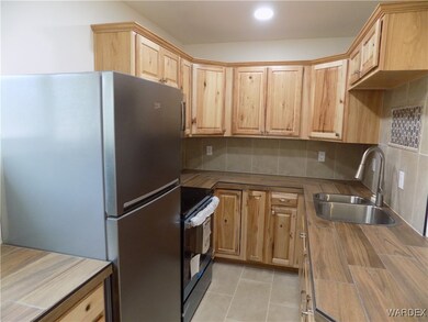 Kitchen with tasteful backsplash, sink, black rang