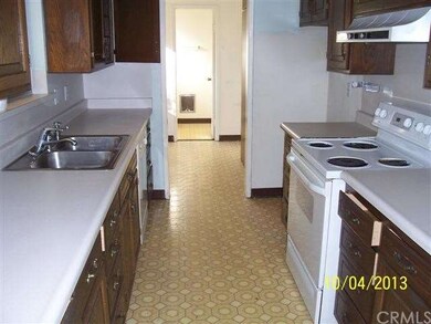 Kitchen w/laundry room in background, half bath.