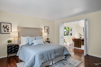 Bedroom with wood finished floors and a chandelier