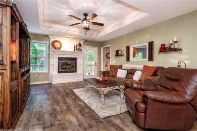 Living room with a new custom fireplace, mantle, hearth and tile.  Trey ceilings in here too!