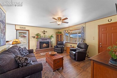 Entry to cozy living room with picture window with water views and wood burning fireplace.