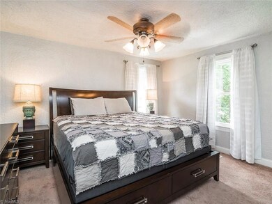 Master bedroom with carpet and great natural light.