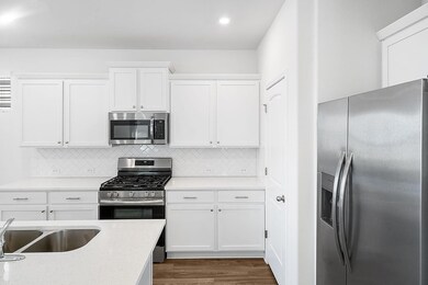 Kitchen featuring appliances with stainless steel