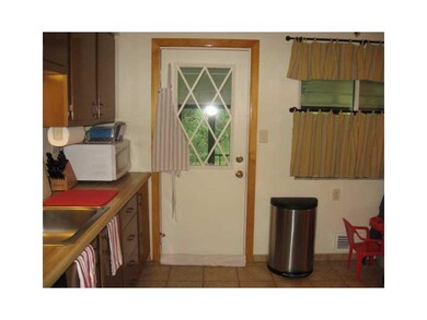 Kitchen. Kitchen door leads to sunroom and yard