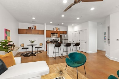 Living room featuring baseboards, finished concre