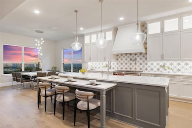 Kitchen featuring white cabinetry, tasteful backs