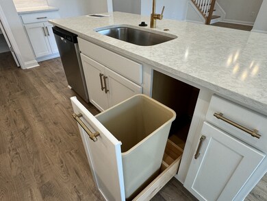 This home has many Kitchen enhancements including the pull out waste basket.