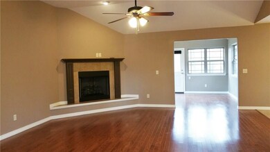 Elegant wood floors lead into the sunny room! Corner fireplace