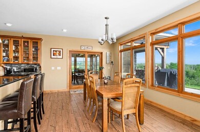 Dining space with light wood-style floors, baseboards, a chandelier, and recessed lighting