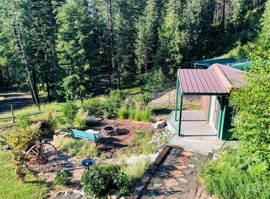 View of yard with a fire pit and a wooded view